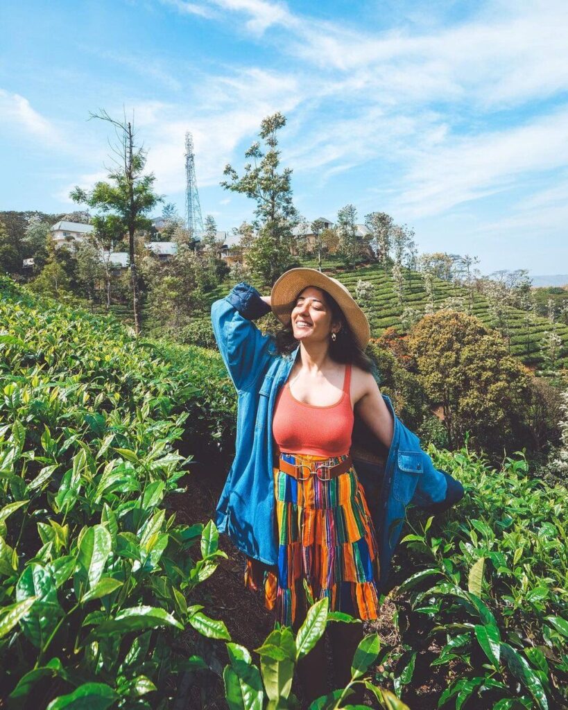 Women traveler exploring lush tea plantations as part of Kerala tour packages