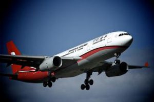 Commercial airplane flying in the sky – perfect for Kerala tour packages travel guide