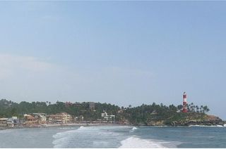 Tourists relaxing at Hawa Beach Kovalam on an Alleppey to Kovalam Kerala tour itinerary