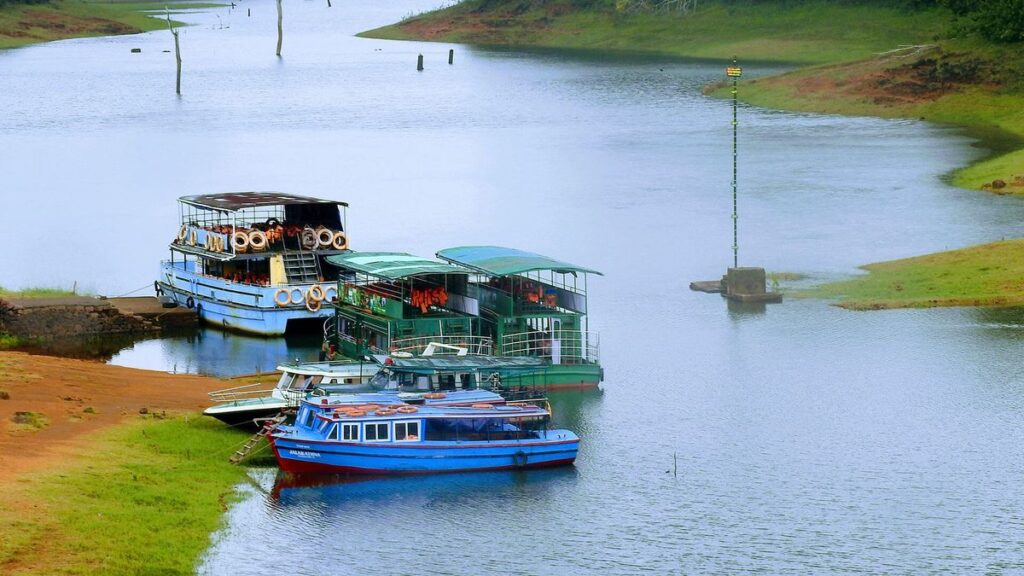 Thekkady in summer view of Periyar Lake with forest hills and boating experience in Kerala