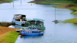 Thekkady in summer view of Periyar Lake with forest hills and boating experience in Kerala